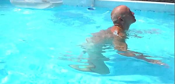  Inked blonde teen joins to grandpa in the pool outdoor